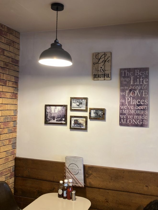A quiet corner table under a pendant lamp.