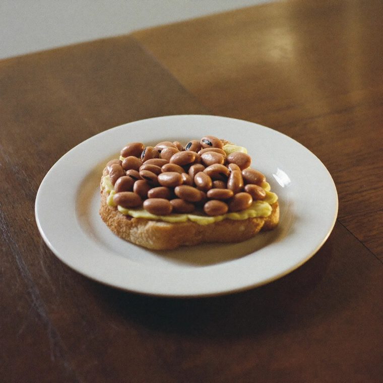 Beans on toast on a white plate.